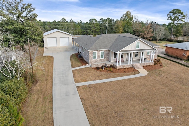 single story home with a garage, an outdoor structure, covered porch, and a front lawn