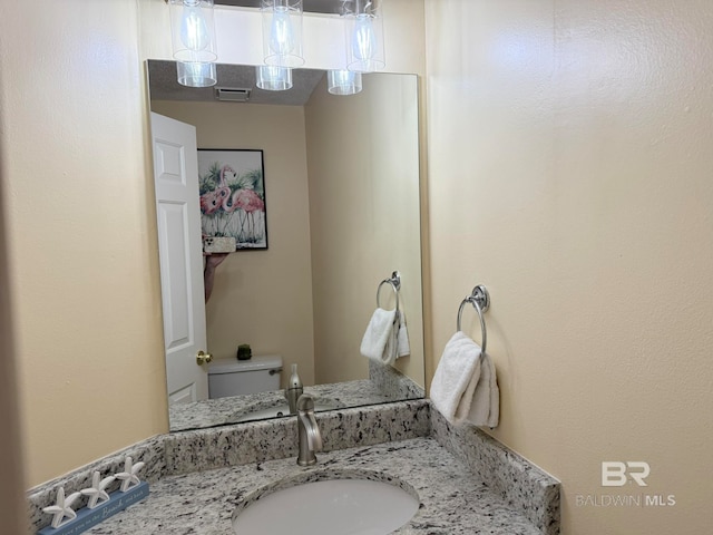 bathroom featuring vanity and toilet