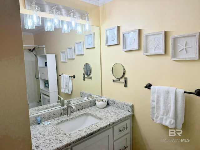 bathroom with vanity, ornamental molding, and walk in shower