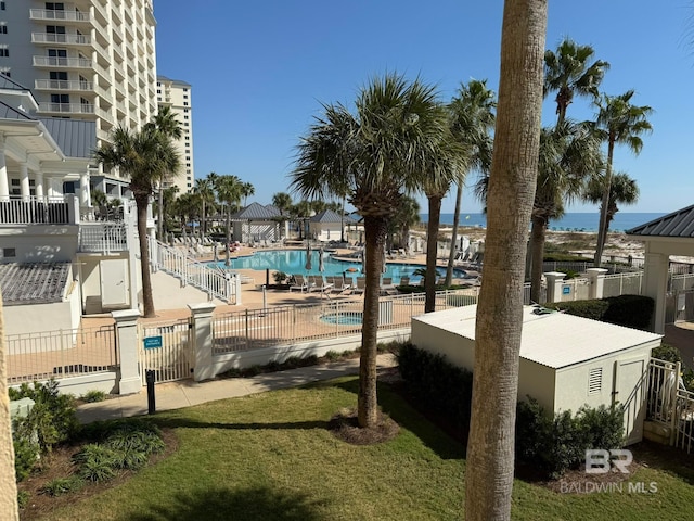 view of pool with a lawn