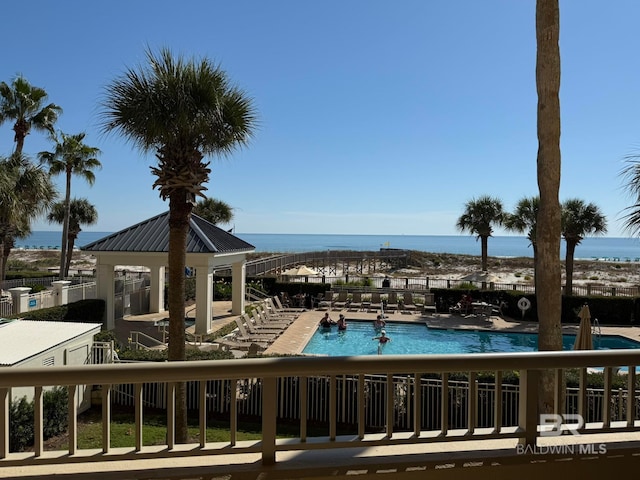 view of pool with a patio and a water view