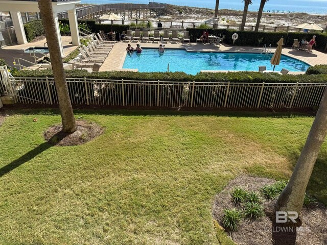 view of swimming pool featuring a yard and a patio area