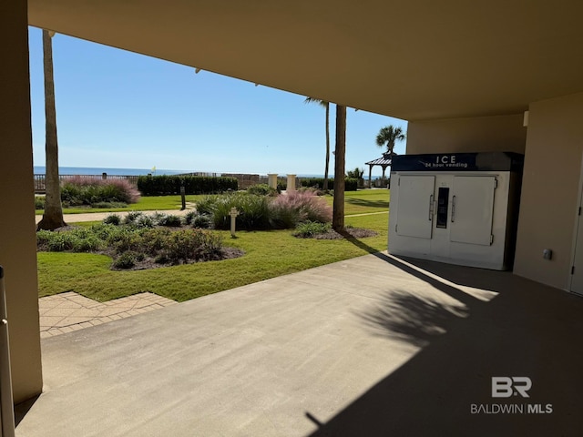 view of patio / terrace with electric panel and a water view