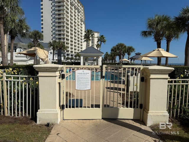 view of gate with a community pool