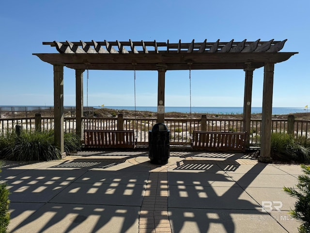 view of patio / terrace featuring a water view and a pergola