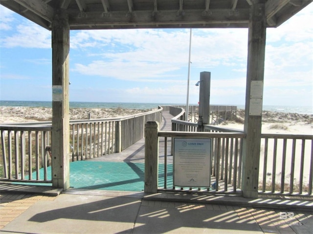 exterior space with a water view and a beach view