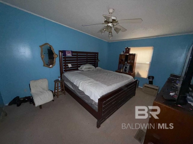 bedroom featuring a textured ceiling, carpet floors, a ceiling fan, and crown molding