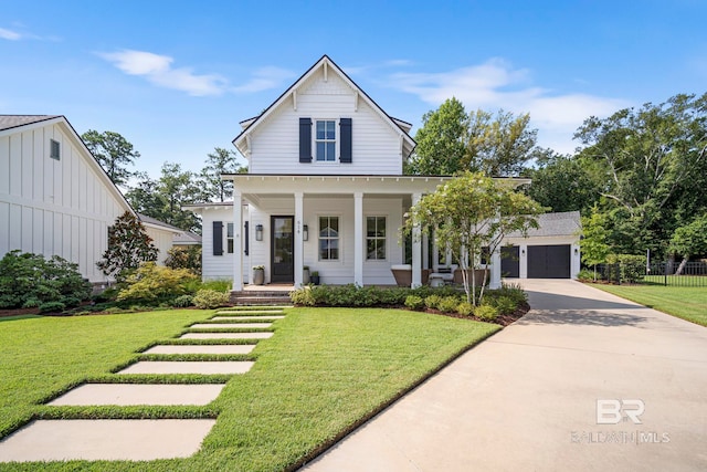 modern farmhouse style home featuring a garage, covered porch, and a front yard