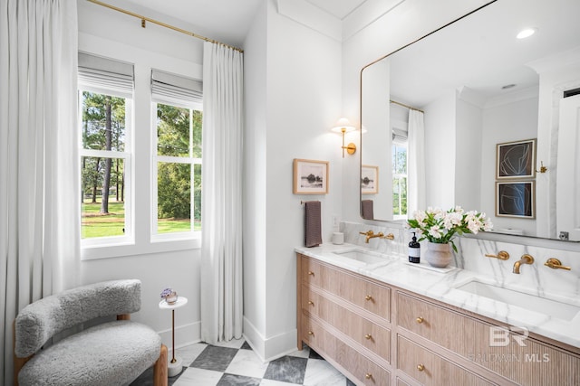 bathroom featuring ornamental molding, vanity, and a wealth of natural light