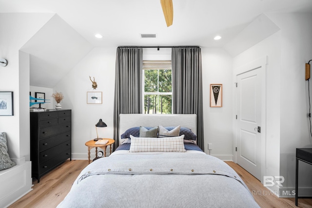 bedroom featuring light hardwood / wood-style flooring and vaulted ceiling