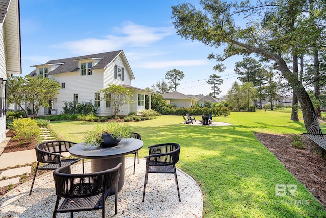 view of yard with a patio and an outdoor fire pit