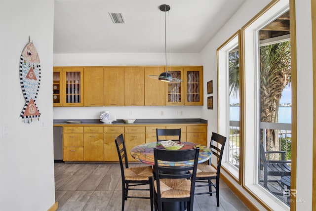 7166 Sharp Reef, Pensacola, FL 32507 - kitchen with plenty of natural light, glass insert cabinets, and pendant lighting