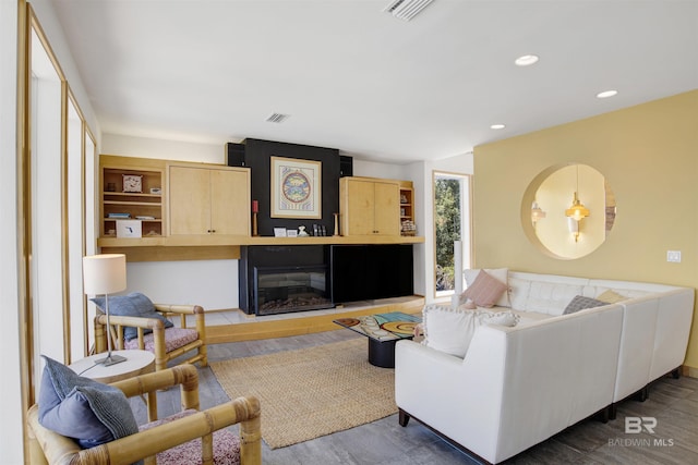 7166 Sharp Reef, Pensacola, FL 32507 - living room featuring wood finished floors, a glass covered fireplace, and recessed lighting