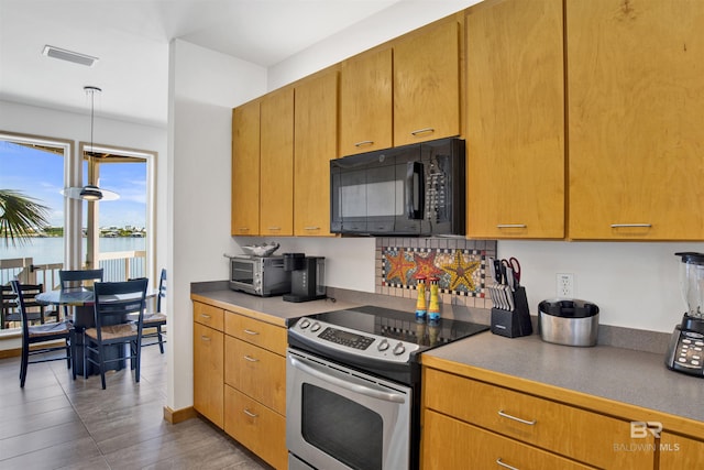 7166 Sharp Reef, Pensacola, FL 32507 - kitchen featuring black microwave, stainless steel electric range oven, decorative light fixtures, wood finished floors, and a water view