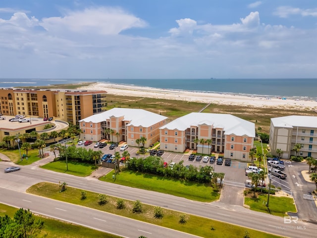 birds eye view of property featuring a water view and a view of the beach