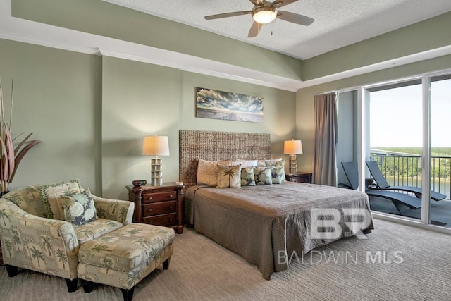 carpeted bedroom with ceiling fan, access to exterior, and a textured ceiling