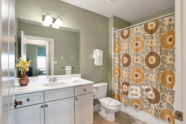 full bathroom with tile patterned floors, vanity, toilet, and shower / bath combo