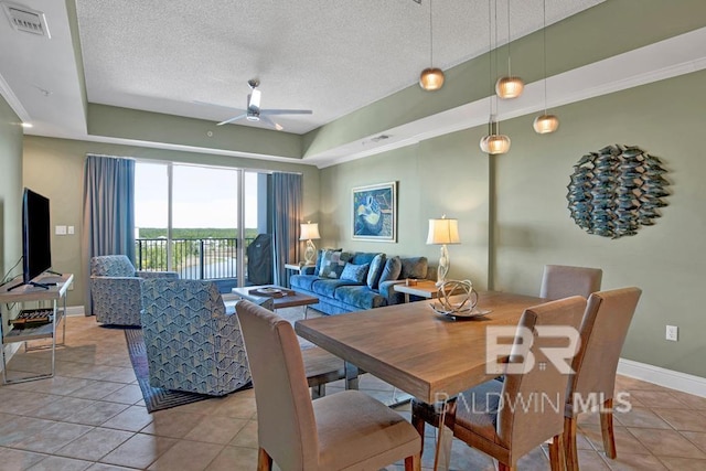 tiled dining room featuring a textured ceiling and ceiling fan