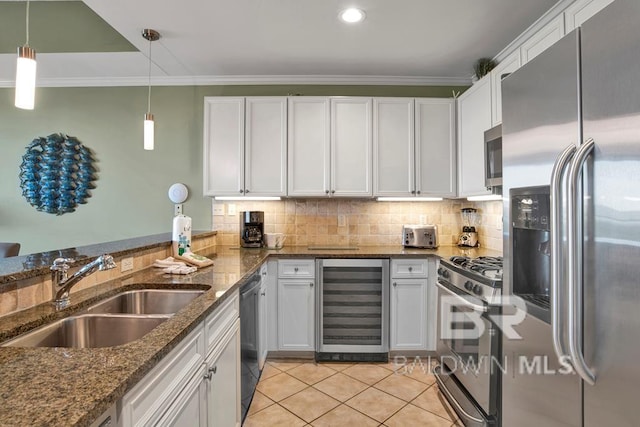 kitchen featuring hanging light fixtures, wine cooler, sink, appliances with stainless steel finishes, and white cabinetry