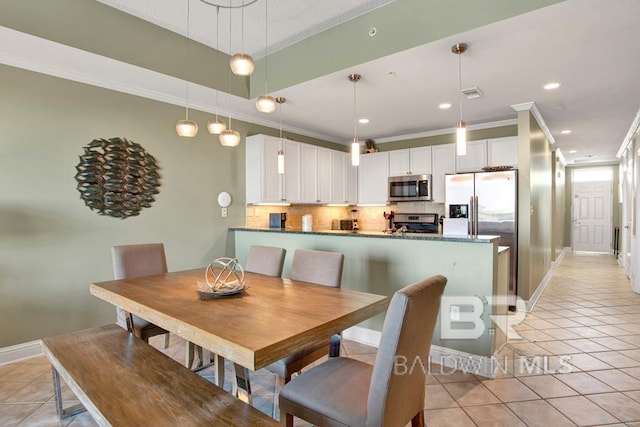 tiled dining space with crown molding