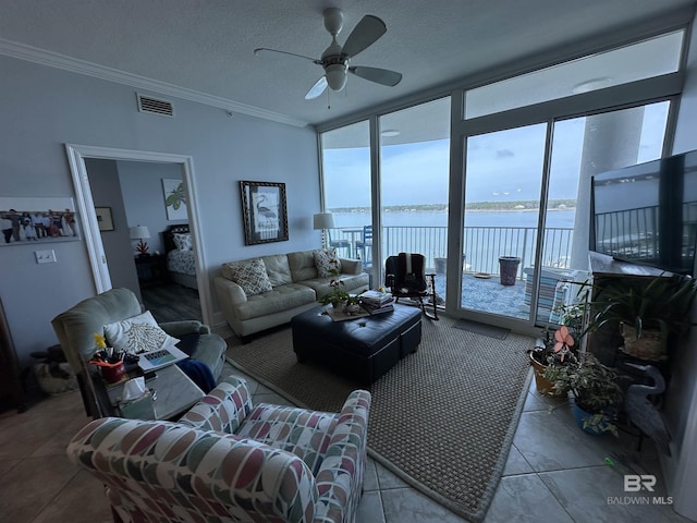 living room featuring ceiling fan, ornamental molding, floor to ceiling windows, and a textured ceiling