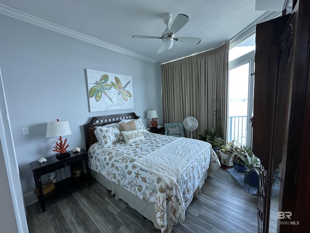 bedroom with ceiling fan, ornamental molding, dark hardwood / wood-style flooring, and a textured ceiling