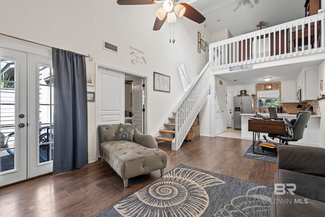 living room featuring french doors, hardwood / wood-style flooring, a high ceiling, and ceiling fan