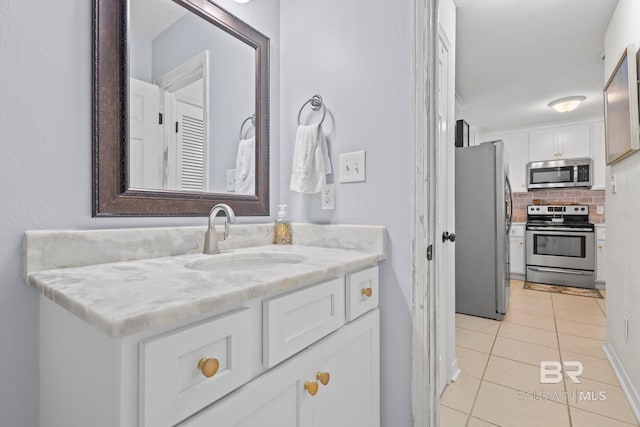 bathroom featuring tile patterned flooring and vanity