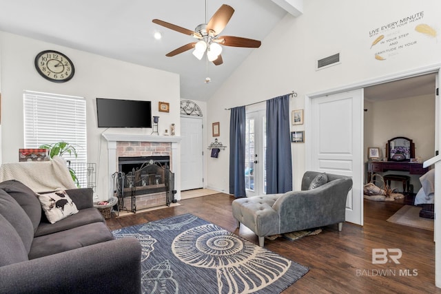 living room with ceiling fan, beam ceiling, a brick fireplace, dark wood-type flooring, and high vaulted ceiling