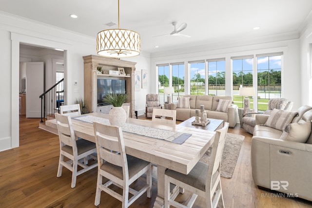902 Inlet Cir, Gulf Shores, AL 36542 - dining room with visible vents, ornamental molding, a ceiling fan, wood finished floors, and stairs