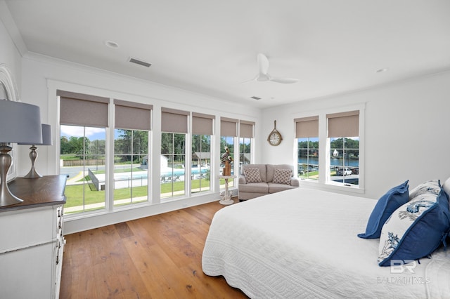 902 Inlet Cir, Gulf Shores, AL 36542 - bedroom with crown molding, visible vents, wood-type flooring, and ceiling fan