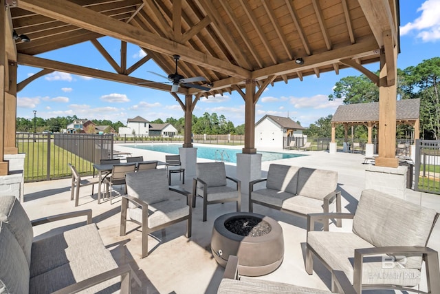 902 Inlet Cir, Gulf Shores, AL 36542 - view of patio / terrace with a gazebo, an outdoor living space with a fire pit, fence, and a community pool