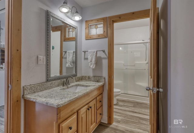 13450 County Road 91, Elberta, AL 36530 - bathroom with hardwood / wood-style flooring, a shower with door, vanity, and toilet