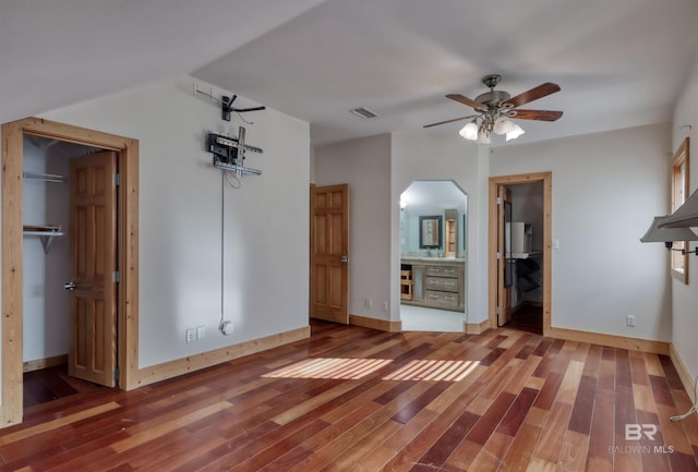 13450 County Road 91, Elberta, AL 36530 - unfurnished bedroom with ensuite bathroom, a closet, ceiling fan, and wood-type flooring