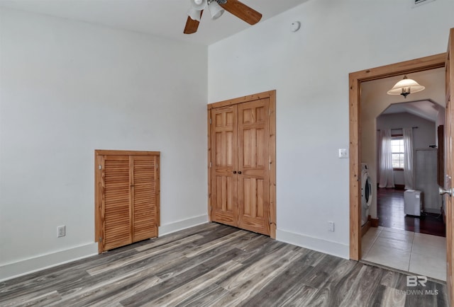 13450 County Road 91, Elberta, AL 36530 - unfurnished bedroom with washer / clothes dryer, ceiling fan, and dark hardwood / wood-style flooring