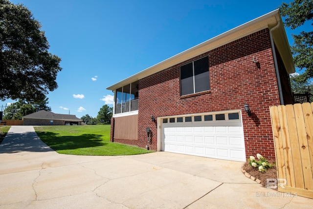 view of side of home with a garage and a lawn