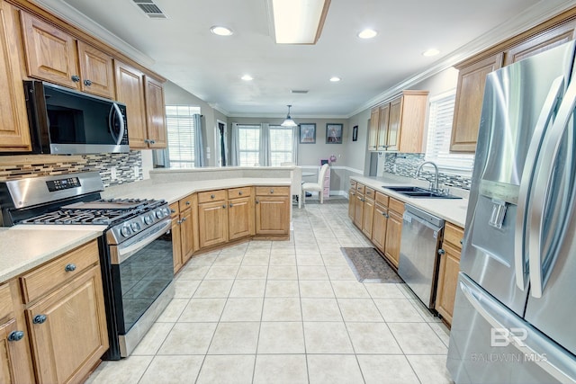 kitchen featuring decorative light fixtures, tasteful backsplash, stainless steel appliances, sink, and light tile patterned floors