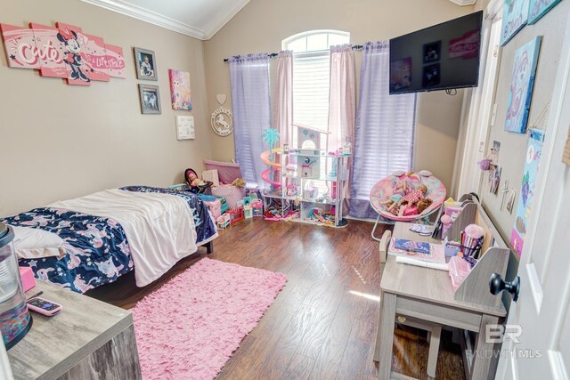 bedroom with lofted ceiling, hardwood / wood-style flooring, and crown molding