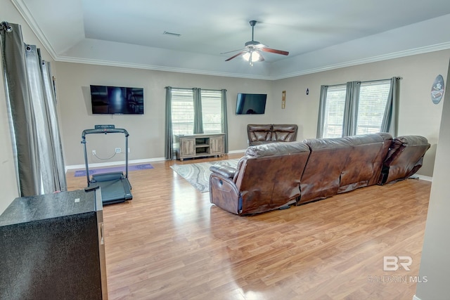 living room with plenty of natural light, light hardwood / wood-style floors, and ceiling fan