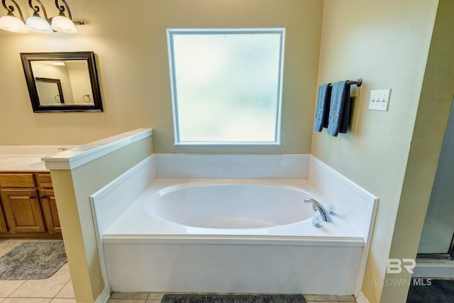 bathroom featuring tile patterned floors, vanity, and a tub to relax in