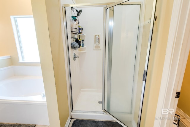 bathroom with a healthy amount of sunlight and plus walk in shower