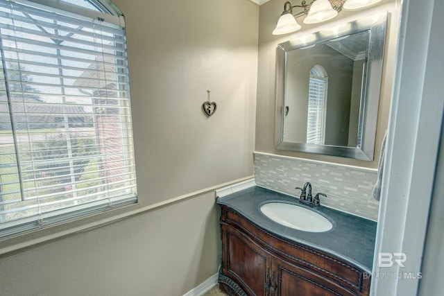 bathroom featuring vanity and backsplash