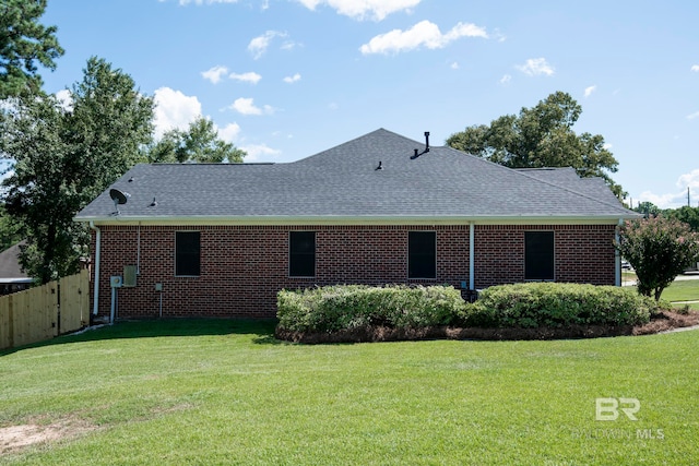 rear view of house featuring a yard