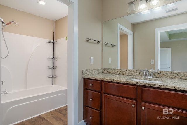 211 Lakefront Cir, Summerdale, AL 36580 - bathroom with vanity, wood finished floors, and shower / bathtub combination