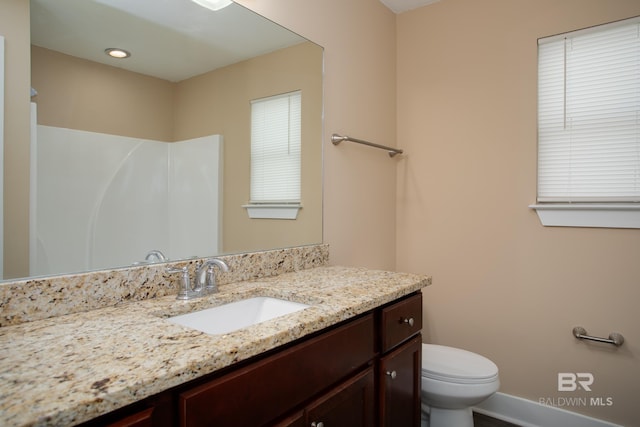211 Lakefront Cir, Summerdale, AL 36580 - bathroom featuring vanity, toilet, baseboards, and a shower