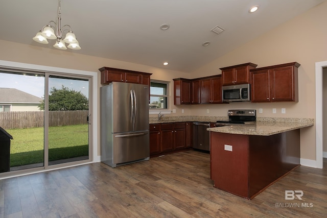 211 Lakefront Cir, Summerdale, AL 36580 - kitchen with stainless steel appliances, a peninsula, a chandelier, dark wood-style flooring, and vaulted ceiling