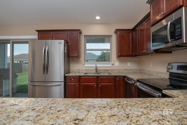 211 Lakefront Cir, Summerdale, AL 36580 - kitchen featuring appliances with stainless steel finishes, a sink, healthy amount of natural light, recessed lighting, and light stone counters