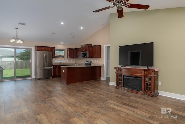 211 Lakefront Cir, Summerdale, AL 36580 - kitchen featuring appliances with stainless steel finishes, open floor plan, high vaulted ceiling, a peninsula, and a chandelier