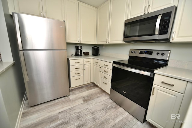 kitchen with light hardwood / wood-style flooring and stainless steel appliances