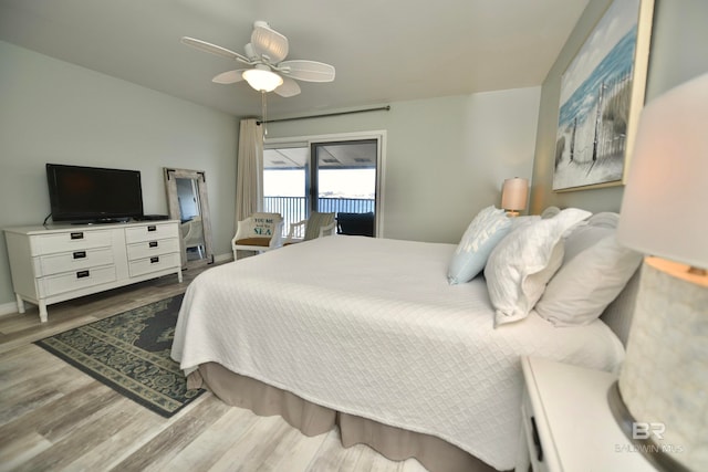 bedroom featuring light hardwood / wood-style floors, ceiling fan, and access to outside